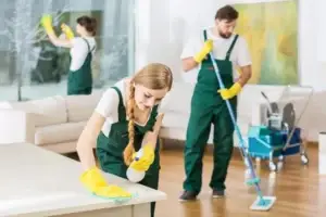 Professional cleaning team sanitizing a luxury hotel room in New York City.